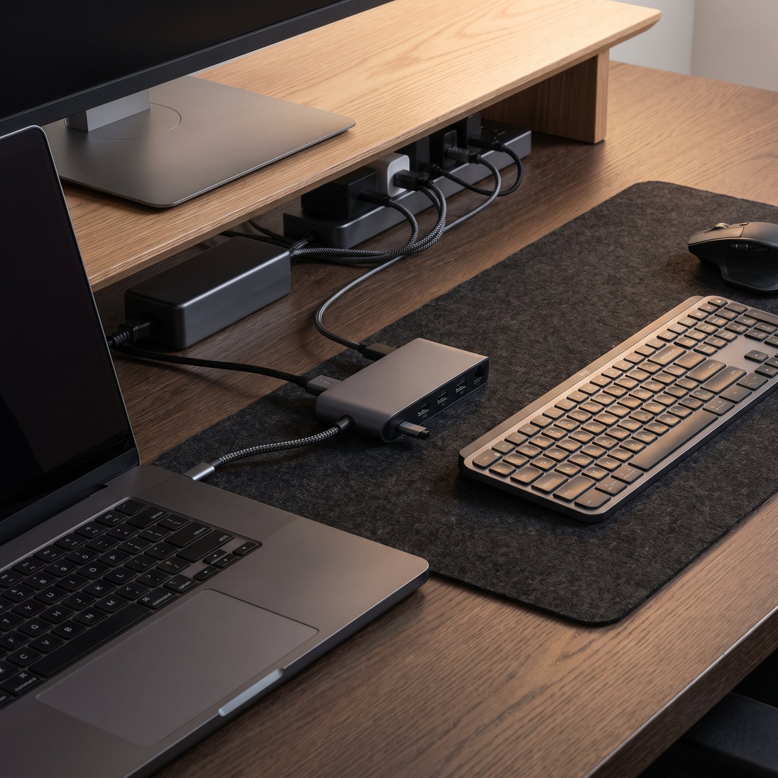 laptop USB-C hub and power connectivity setup on a home office desk
